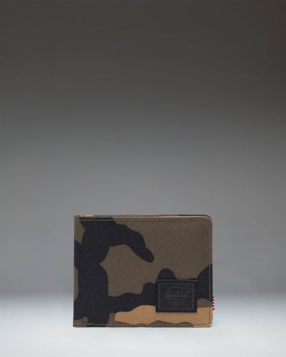 Herschel Supply Co Roy Wallet in Woodland Camo with a black classic woven label on the front, showing the bi-fold exterior design.