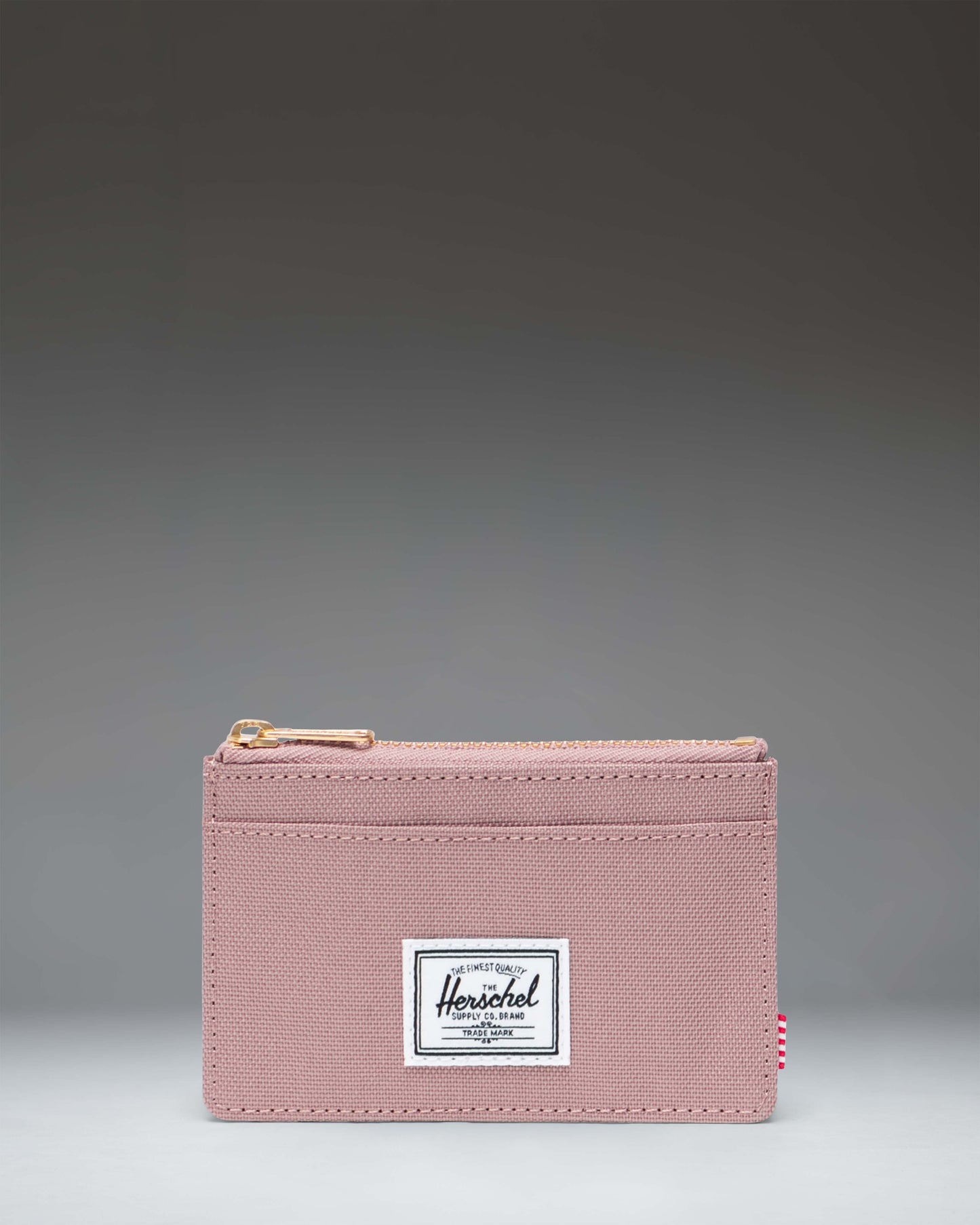 Herschel Supply Co. Oscar Cardholder wallet in Ash Rose pink showing a front view with card slots and a main zip compartment.