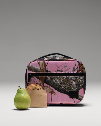 Herschel Supply Co. Realtree Pop Quiz Lunch Box in Realtree Edge Camo Pink/Black featuring a durable, insulated main compartment.