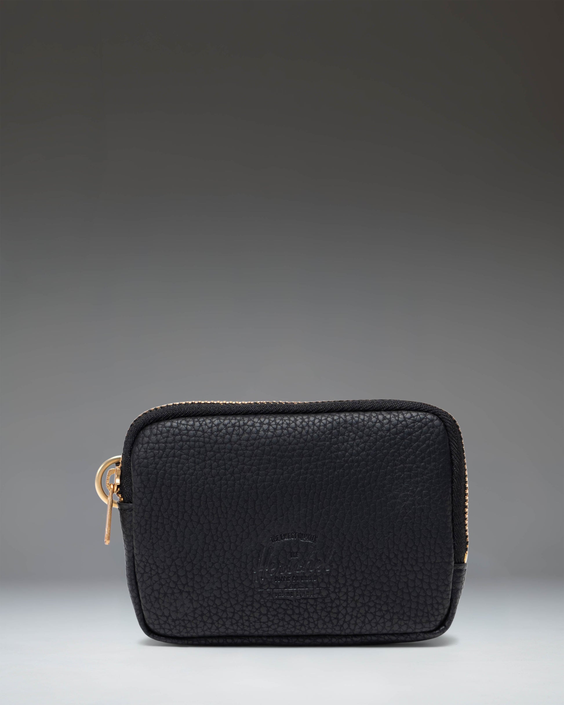 Herschel Supply Co. Oxford Pouch in black vegan leather, featuring a sleek, zippered design for organizing small essentials.