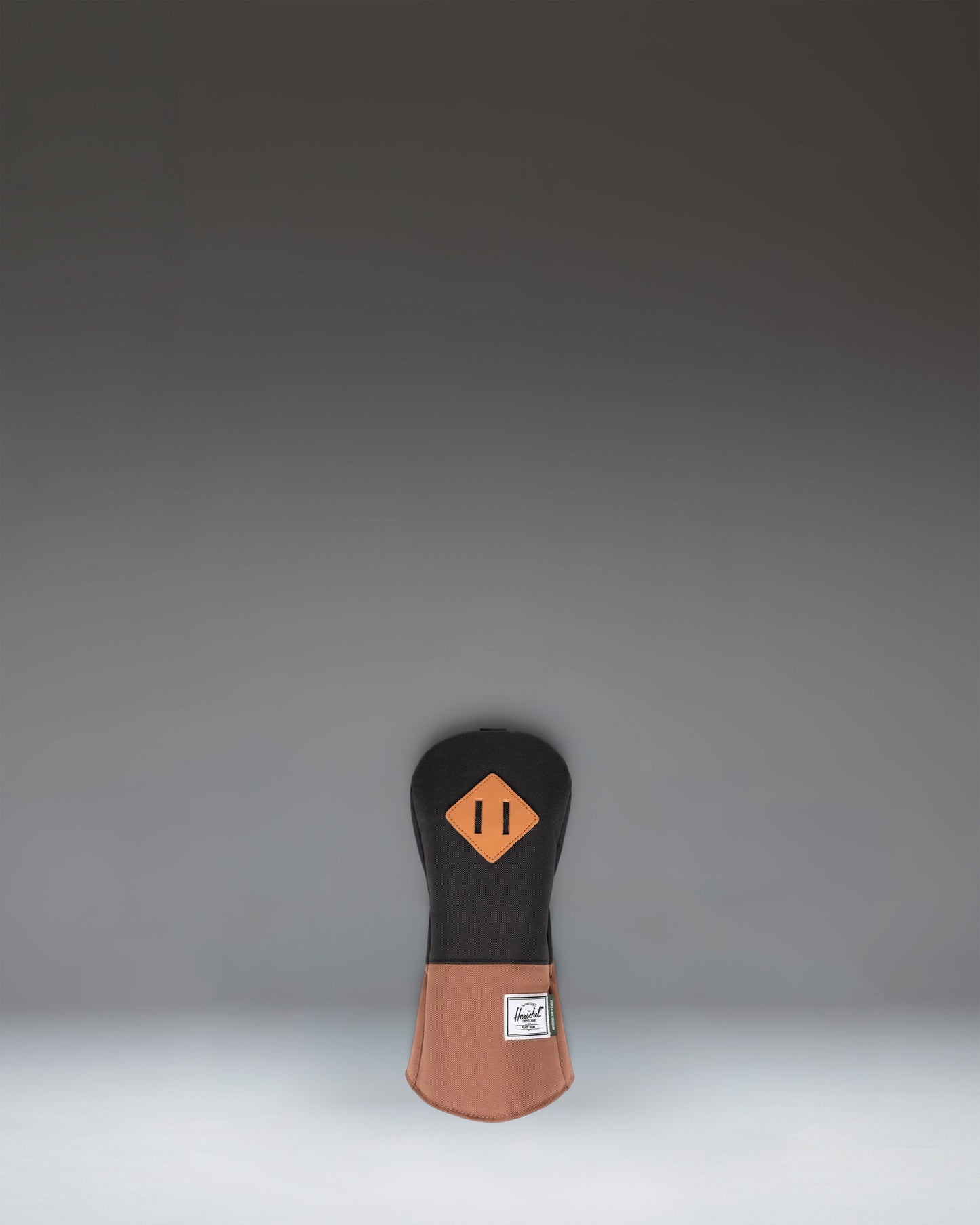 Herschel Supply Co. Heritage Fairway Wood Head Cover in black with a saddle brown base and a classic diamond accent detail.