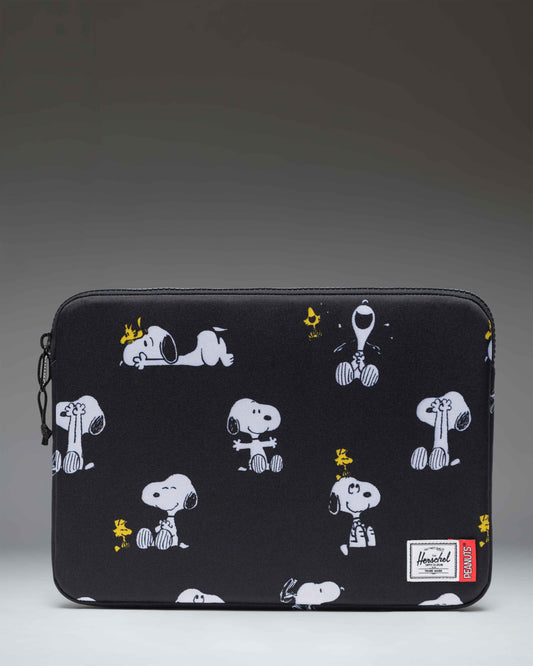 Herschel Supply Co. Peanuts Anchor 14 Inch Sleeve in Snoopy and Woodstock Black, featuring a repeating print of Snoopy and Woodstock.