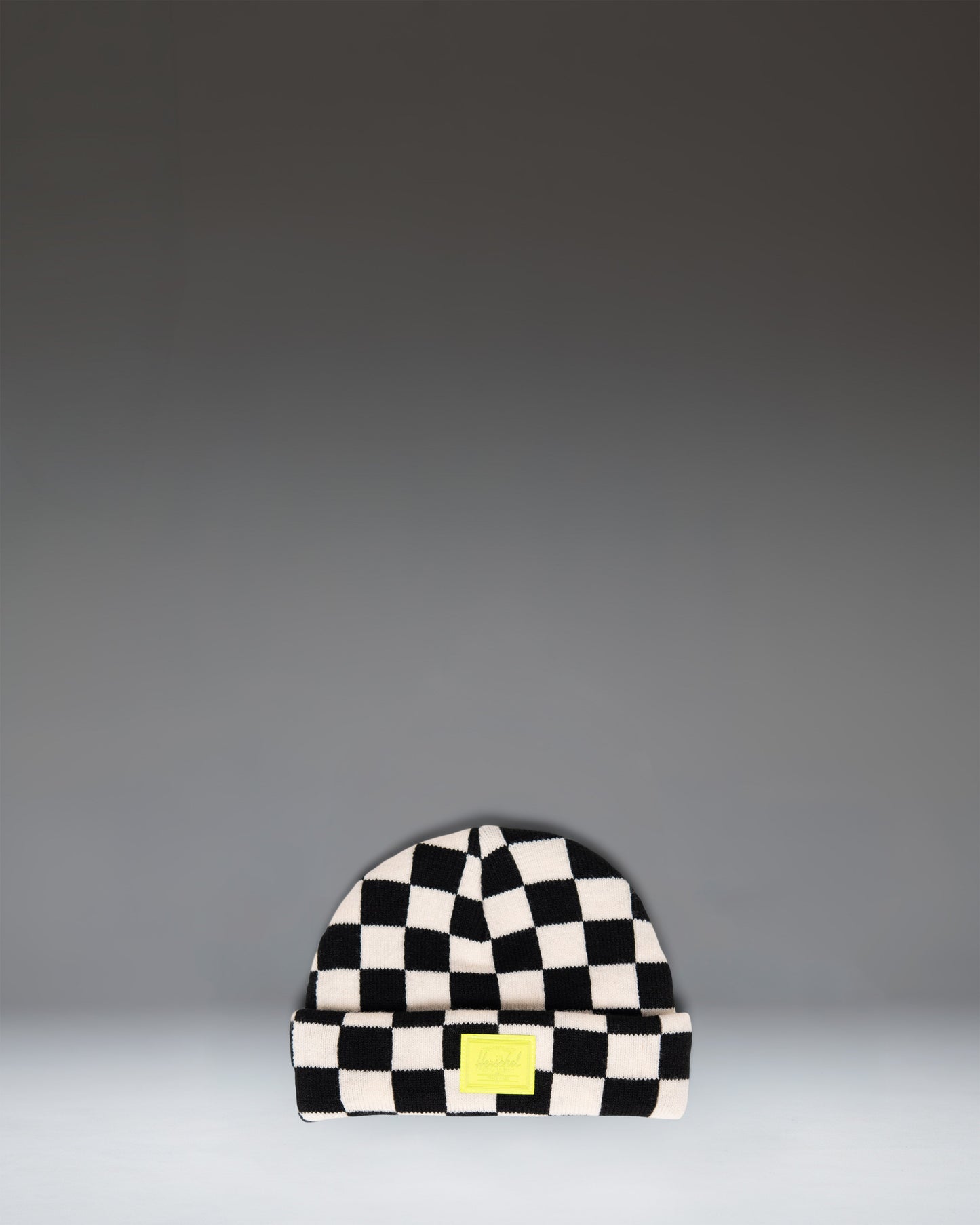 Herschel Supply Co. Elmer Baby Graphic Beanie 0–6 Months in a black and white checkerboard pattern.