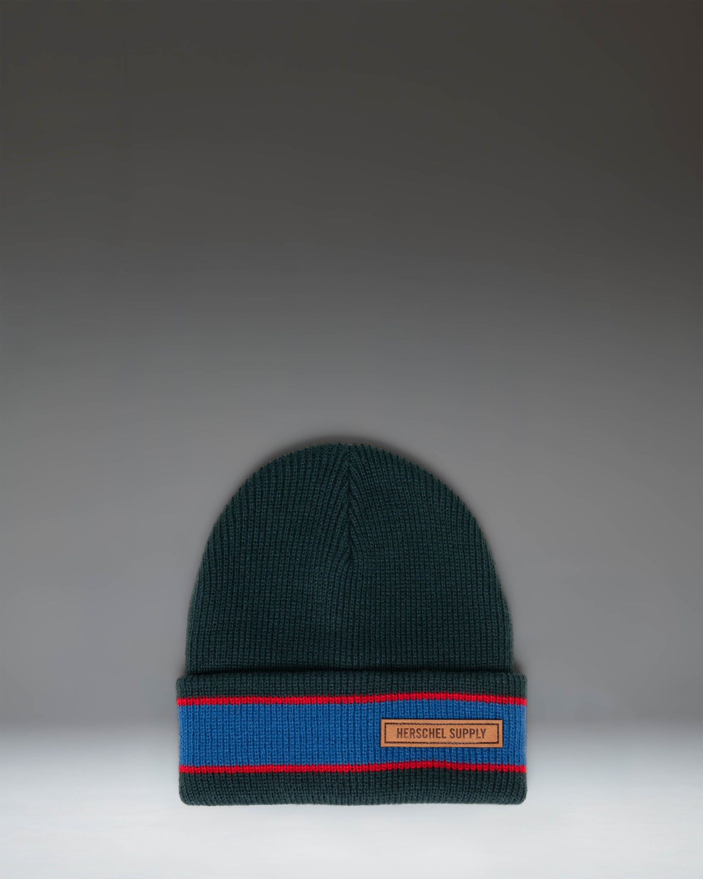 Herschel Supply Co. Elmer Ribbed Vintage Stripe beanie in Ponderosa Pine green, featuring a classic cuffed design and a woven logo label.