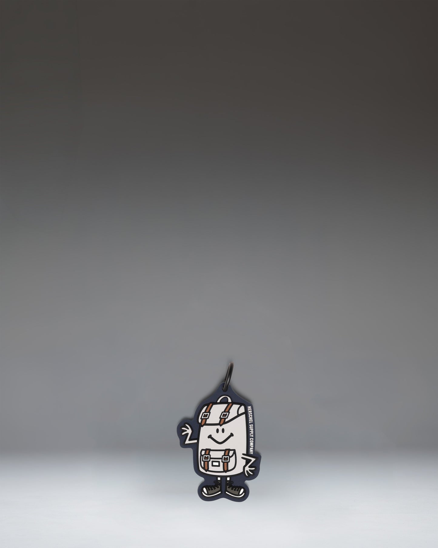 Herschel Supply Co. Sam Bag Charm Little Herschel in Mood Indigo, featuring a miniature backpack design with a front pocket and zipper details.