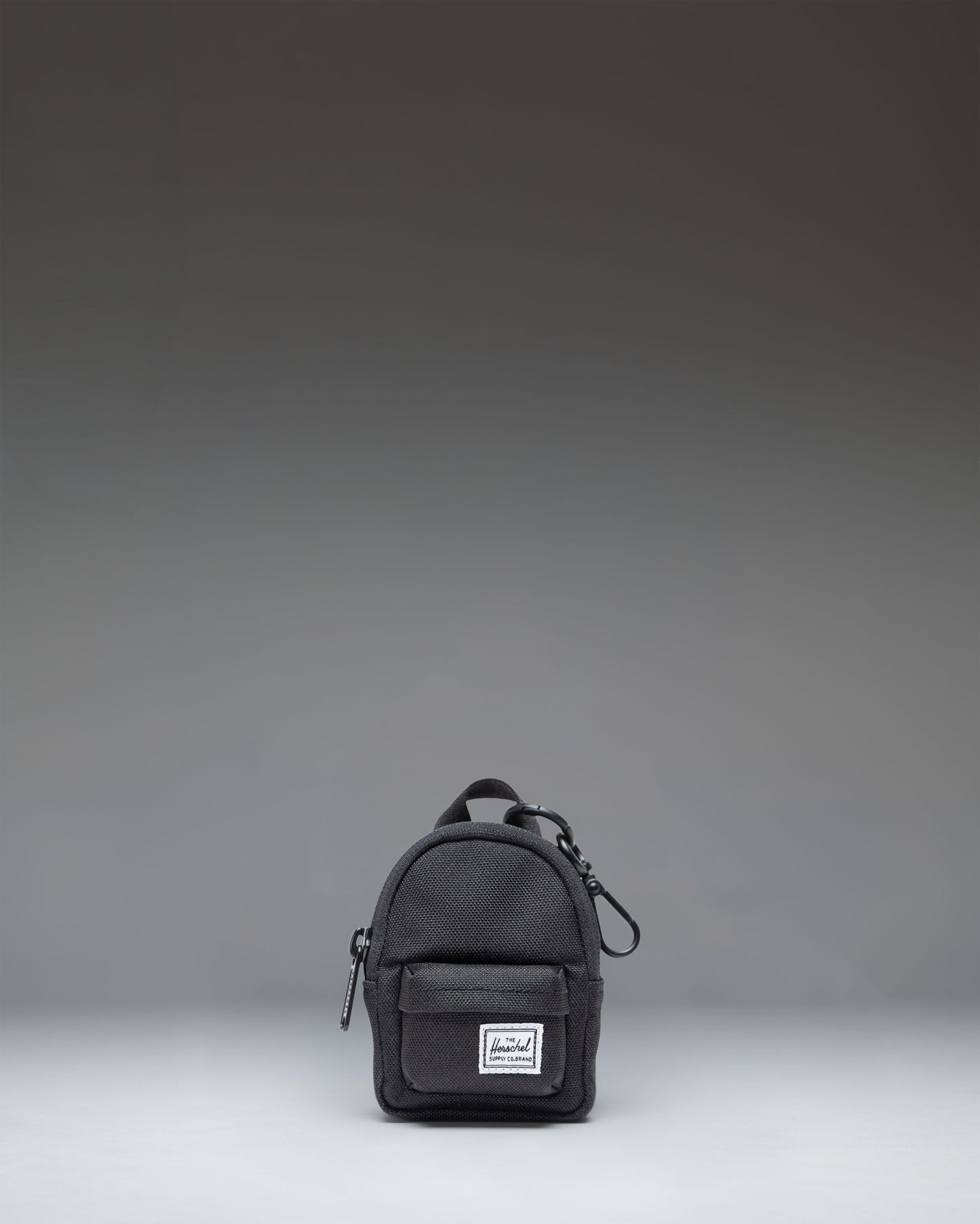 Herschel Classic Backpack Bag Charm in black, showing the front view of a miniature backpack keychain accessory.