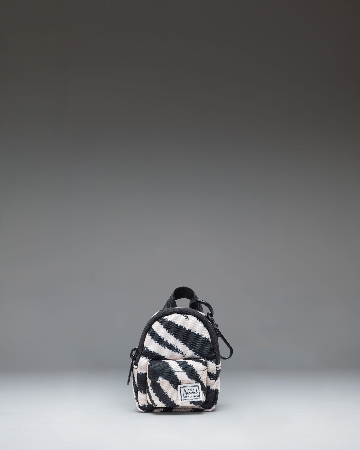 Herschel Classic Backpack Bag Charm in a striking black and white zebra print pattern.