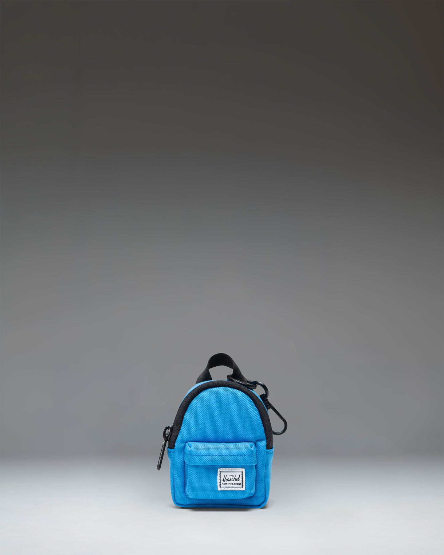 Herschel Classic Backpack Bag Charm in French Blue, showcasing its miniature design, zipper closure, and key ring attachment.