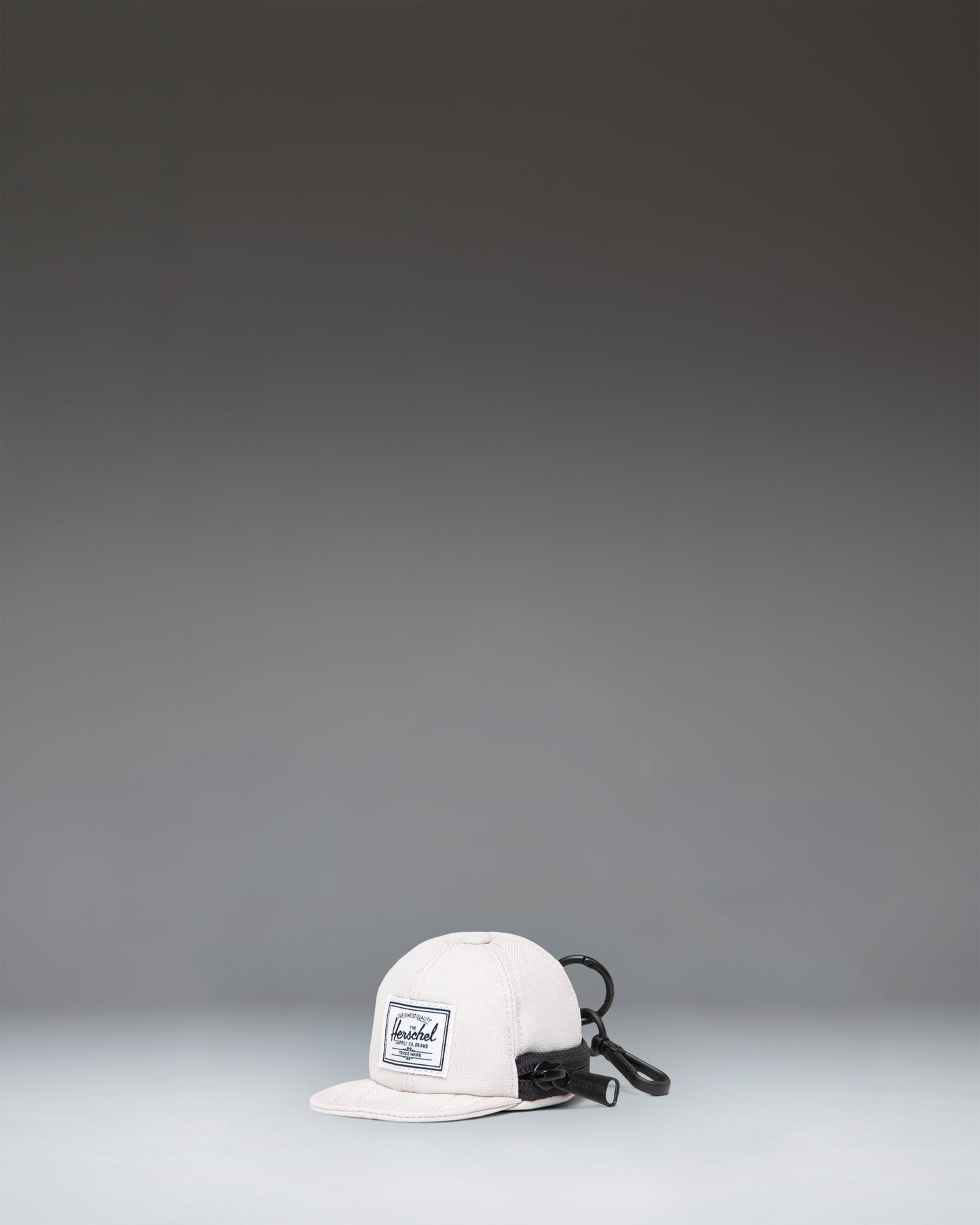 Herschel Supply Co. Sylas Classic Cap Bag Charm in the off-white Moonbeam colorway.