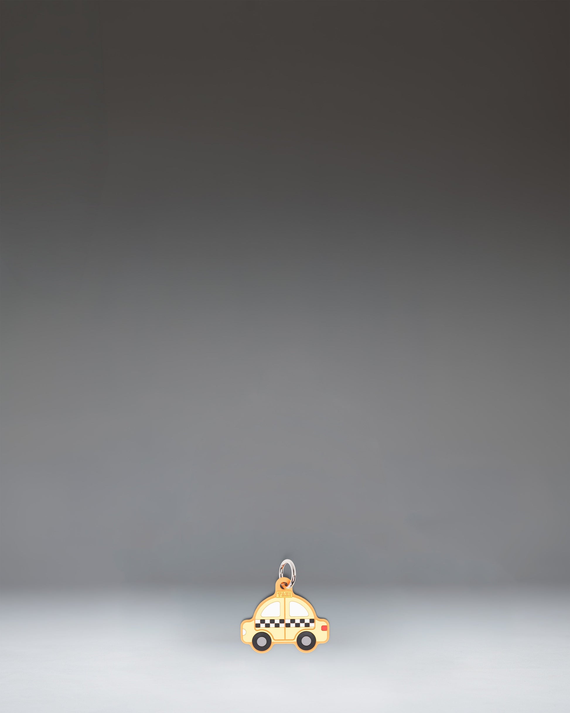 Herschel Taxi Bag Charm in Taxi, a yellow checker-cab-inspired miniature bag accessory with black and white checkered details.